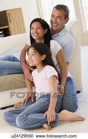 Family in living room smiling View Large Photo Image Stock Image - Family in living room smiling. Fotosearch