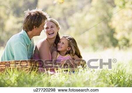 Family at park having a picnic and laughing View Large Photo Image Stock Photo - Family at park having a picnic and laughing. Fotosearch