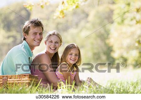 Family at park having a picnic and smiling View Large Photo Image Stock Photograph - Family at park having a picnic and smiling. Fotosearch