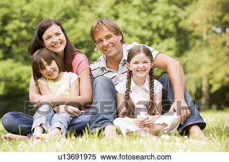 Stock Photography - Family outdoors smiling. Fotosearch