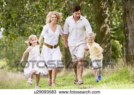 Family running on path holding hands smiling View Large Photo Image Stock Image - Family running on path holding hands smiling. Fotosearch