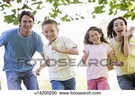 Family running outdoors smiling View Large Photo Image Stock Image - Family running outdoors smiling. Fotosearch