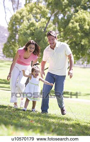 Family running outdoors smiling View Large Photo Image Stock Photo - Family running outdoors smiling. Fotosearch