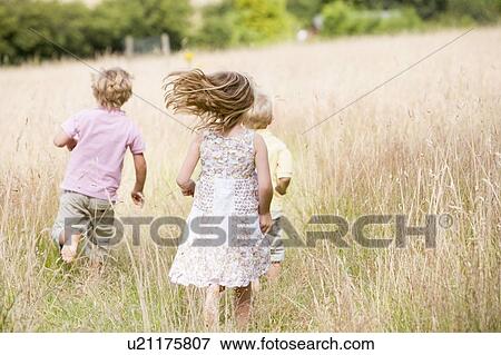Three young children running outdoors View Large Photo Image Stock Photo - Three young children running outdoors. Fotosearch
