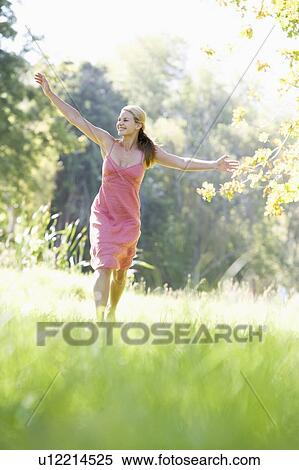 Woman jumping in a park View Large Photo Image Stock Photography - Woman jumping in a park. Fotosearch
