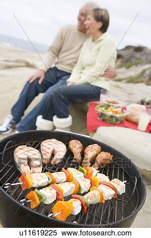 Couple Cooking On A Barbeque View Large Photo Image Stock Photography - Couple Cooking On A Barbeque. Fotosearch