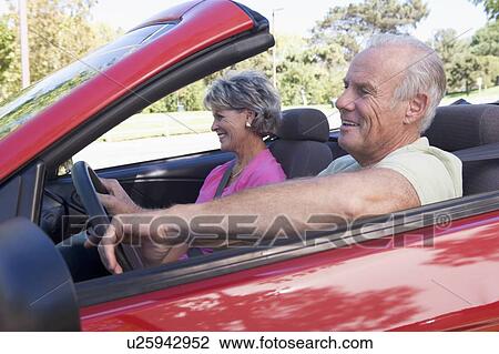 Couple in convertible car smiling View Large Photo Image Stock Image - Couple in convertible car smiling. Fotosearch