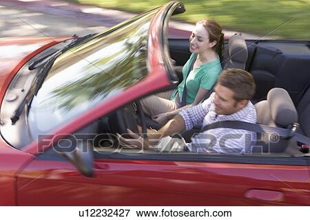 Couple in convertible car smiling View Large Photo Image Stock Photo - Couple in convertible car smiling. Fotosearch