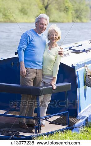 Couple outdoors on a boat smiling View Large Photo Image Stock Photo - Couple outdoors on a boat smiling. Fotosearch