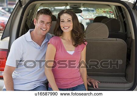 Couple sitting in back of van smiling View Large Photo Image Stock Image - Couple sitting in back of van smiling. Fotosearch