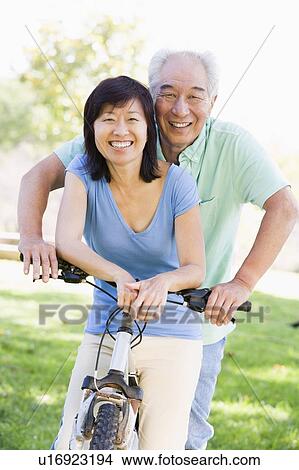 Mature couple bike riding. View Large Photo Image Picture - Mature couple bike riding.. Fotosearch