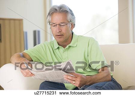Man relaxing with a newspaper View Large Photo Image Stock Image - Man relaxing with a newspaper. Fotosearch