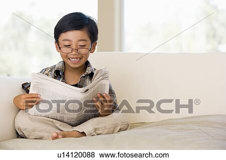 Stock Photo - Young Buy Sitting On A Sofa At Home, Pretending To Be A Grown Up. Fotosearch