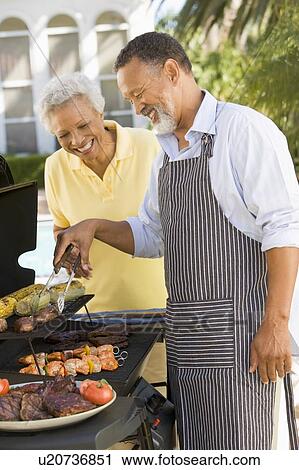 Couple Cooking On A Barbeque View Large Photo Image Stock Image - Couple Cooking On A Barbeque. Fotosearch