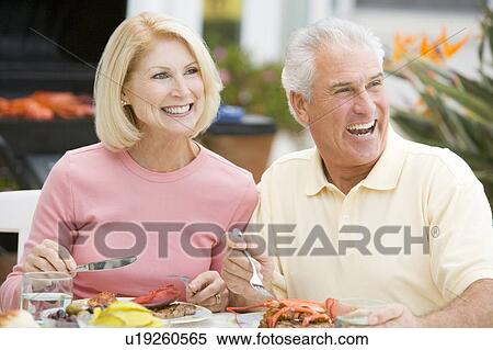 Couple Enjoying A Barbequed Meal In The Garden View Large Photo Image Stock Photography - Couple Enjoying A Barbequed Meal In The Garden. Fotosearch
