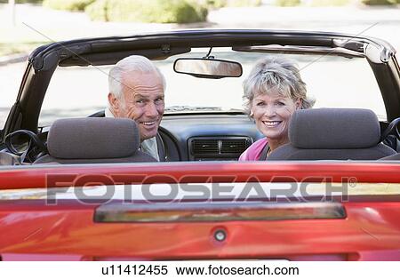 Couple in convertible car smiling View Large Photo Image Stock Photography - Couple in convertible car smiling. Fotosearch
