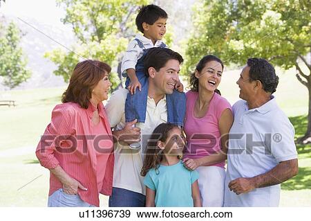 Extended family at the park smiling View Large Photo Image Stock Photo - Extended family at the park smiling. Fotosearch