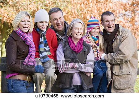 Family outdoors in park smiling (selective focus) View Large Photo Image Stock Photo - Family outdoors in park smiling (selective focus). Fotosearch