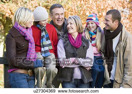 Family outdoors in park smiling (selective focus) View Large Photo Image Stock Photo - Family outdoors in park smiling (selective focus). Fotosearch