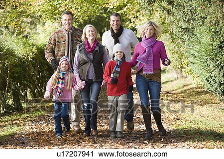 Family walking outdoors in park smiling View Large Photo Image Stock Image - Family walking outdoors in park smiling. Fotosearch