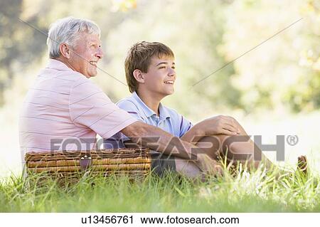 Grandfather and grandson at a picnic smiling View Large Photo Image Stock Image - Grandfather and grandson at a picnic smiling. Fotosearch