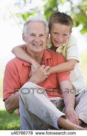 Stock Photo - Grandfather and grandson smiling.. Fotosearch
