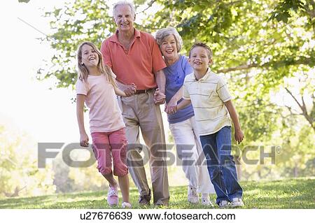 Stock Photo - Grandparents walking with grandchildren.. Fotosearch