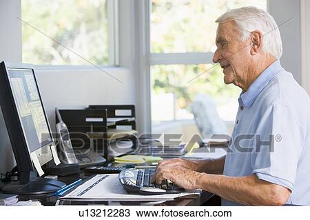 Man in home office using computer smiling View Large Photo Image Stock Image - Man in home office using computer smiling. Fotosearch