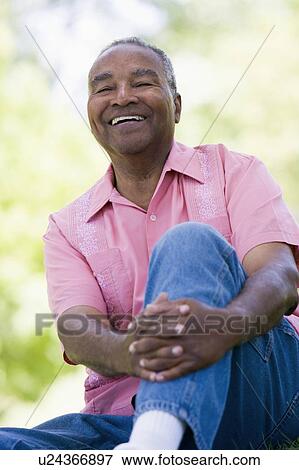 Stock Photo - Senior man sitting outdoors. Fotosearch