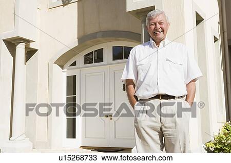 Senior man standing outside his home View Large Photo Image Stock Image - Senior man standing outside his home. Fotosearch