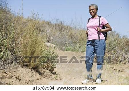 Picture - Senior woman on a walking trail. Fotosearch