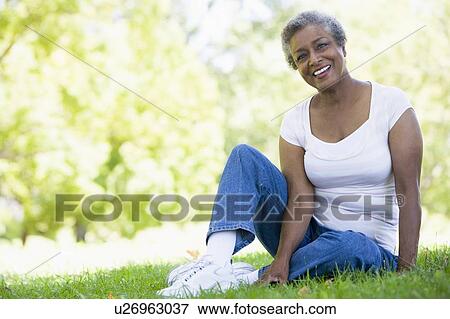 Stock Photo - Senior woman resting in a park. Fotosearch