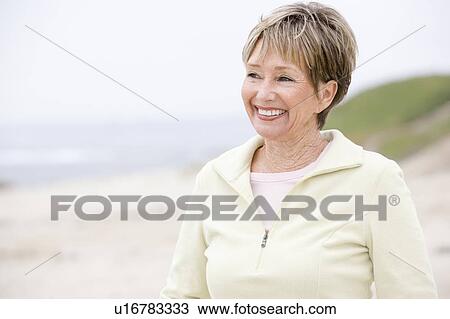 Woman at the beach smiling View Large Photo Image Stock Image - Woman at the beach smiling. Fotosearch