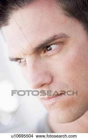 Head shot of man scowling View Large Photo Image Picture - Head shot of man scowling. Fotosearch