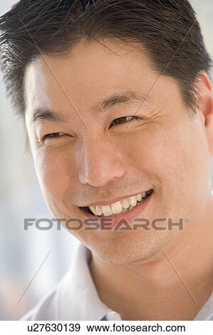 Stock Photo - Head shot of man smiling. Fotosearch