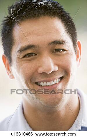 Stock Photograph - Head shot of man smiling. Fotosearch
