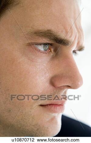 Stock Image - Head shot of man thinking. Fotosearch