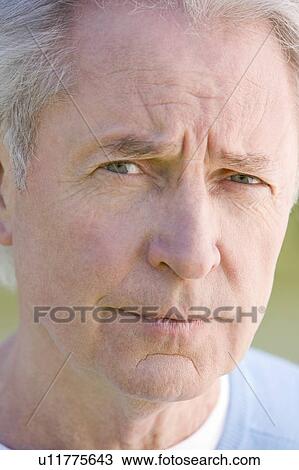 Stock Image - Head shot of man thinking. Fotosearch