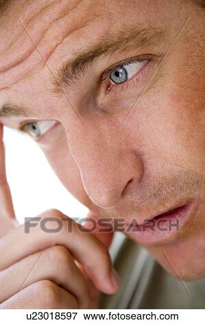 Stock Photo - Head shot of man thinking. Fotosearch