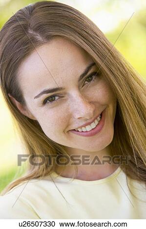 Stock Image - Head shot of woman smiling. Fotosearch