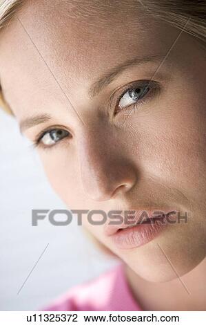 Stock Image - Head shot of woman thinking. Fotosearch