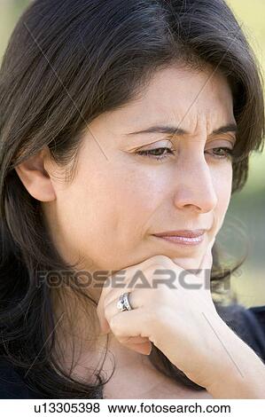 Stock Photo - Head shot of worried woman. Fotosearch