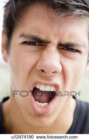 Head shot of man scowling View Large Photo Image Stock Image - Head shot of man scowling. Fotosearch
