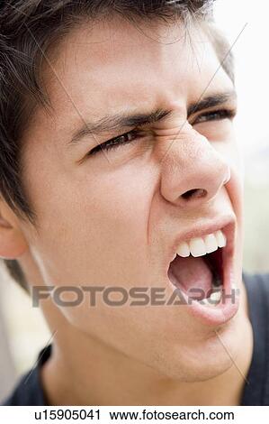 Stock Image - Head shot of man scowling. Fotosearch