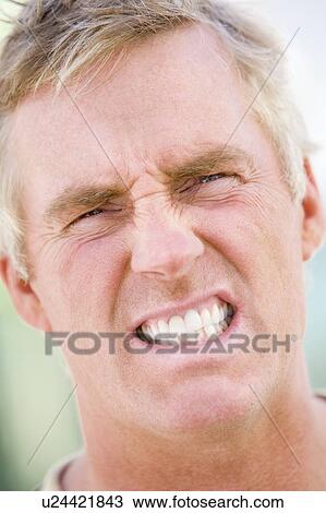Head shot of man scowling View Large Photo Image Stock Image - Head shot of man scowling. Fotosearch