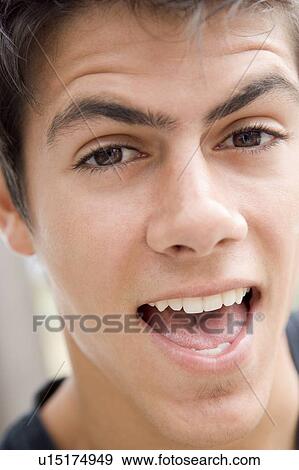 Stock Photo - Head shot of man scowling. Fotosearch