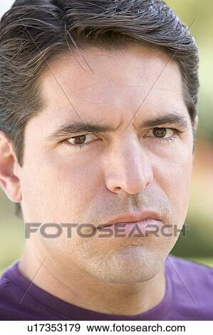 Stock Photo - Head shot of man scowling. Fotosearch