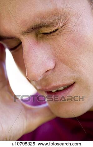 Stock Photography - Head shot of man scowling. Fotosearch