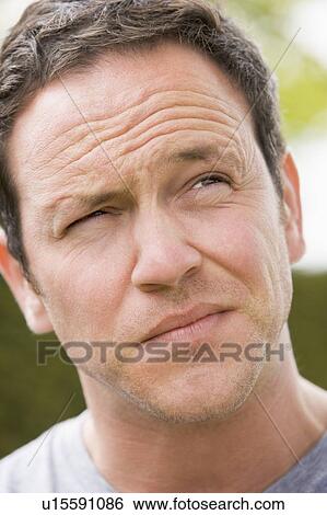 Head shot of man thinking View Large Photo Image Stock Photograph - Head shot of man thinking. Fotosearch