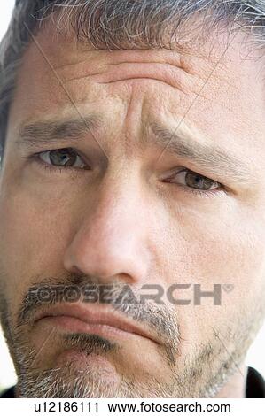 Stock Image - Head shot of sad man. Fotosearch